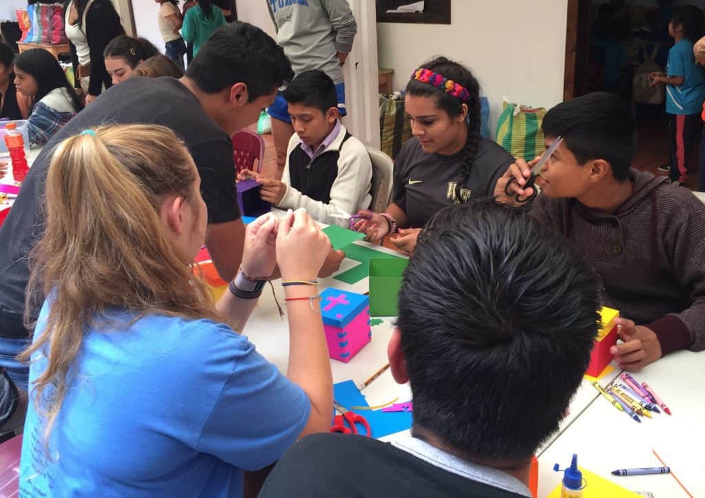 St. John's high schoolers work with Escuela Integrada students on a craft for the residents at Casa Maria in Jocotenango.
