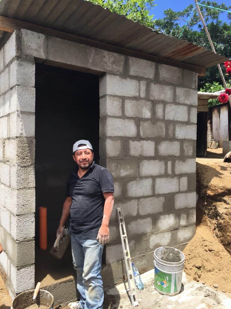 Carlos stands next to the nearly complete bathroom on Friday, Aug. 4, 2017.