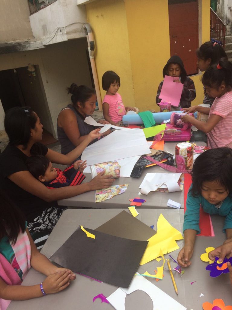Morales leads a craft project for the girls in Proyecto Capaz.