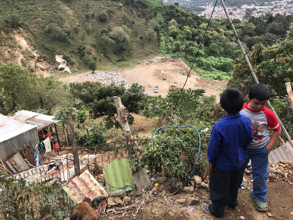 Kids from Escuela Integrada look down from one of their homes toward the local dump in Jocotenango on Nov. 7, 2017.