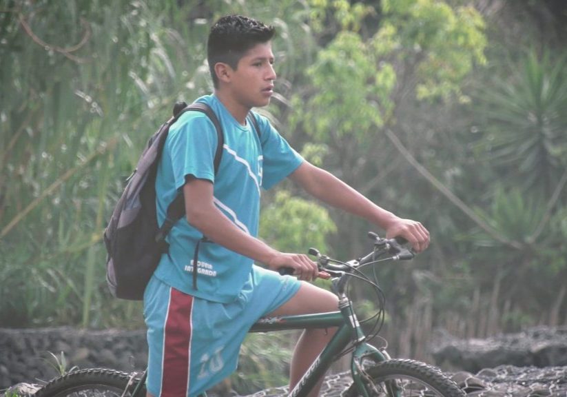 Day In The Life - Selects.00_02_44_08.Still003 Eli rides his bike 4.6 miles to and from Escuela Integrada. He traverses steep mountainsides and busy streets to get to school each day. The new Escuela Integrada film follows his daily experience.