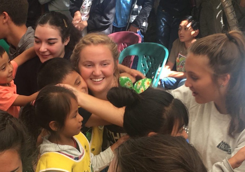 JulianaAnderson1 High school graduate Juliana Anderson receives a hug from a child at Escuela Integrada on July 3, 2017.