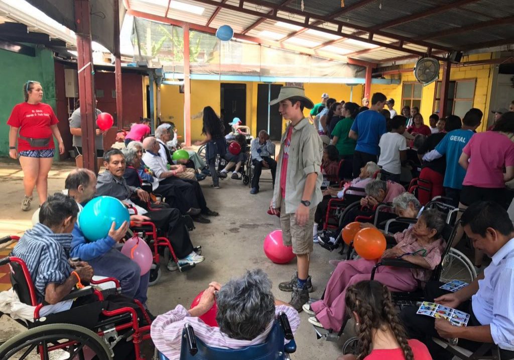 StJohnsCasaMaria2 Jared Hensley helps with a game for residents at Casa Maria.