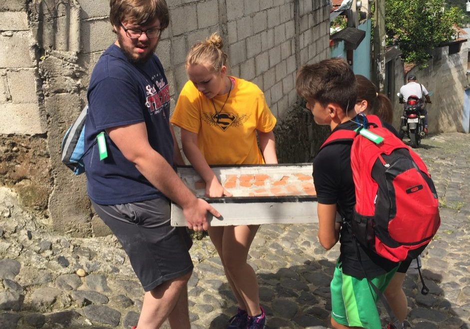 Stoves7 A mission group from St. John's Lutheran Church in Salisbury, North Carolina, carries part of a stove up a hill in San Felipe. The group built a stove for one of the Escuela Integrada families on Wednesday, July 12, 2017.